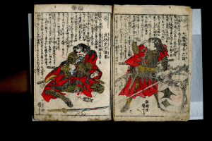 Offenes Buch mit dem Titel "Utagawa Kunisada Toyokuni III/Kuniyoshi Toyokubi III" aus der Serie *Fünfzig-Three Stations of the Tokaido*, zeigt eine detaillierte Illustration von zwei Samurai-Kriegern in einem heftigen Kampf mit gezückten Schwertern.