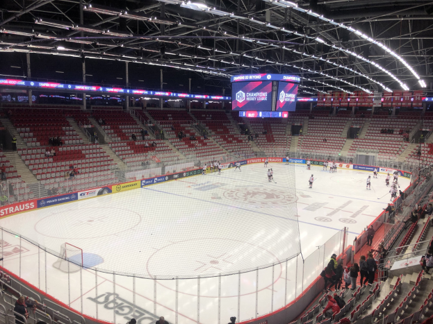 Eishockeyspiel in einer großen Arena zwischen den St. Louis Blues und Detroit Red Wings, mit Zuschauern auf Sitzen und Stehplätzen in der Nähe der Eisfläche.